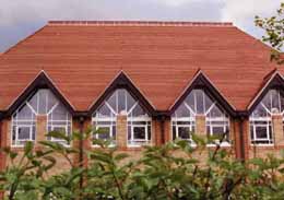 Roding Valley School Red sandfaced with Club and fishtail tiles and 2 hole crested ridges